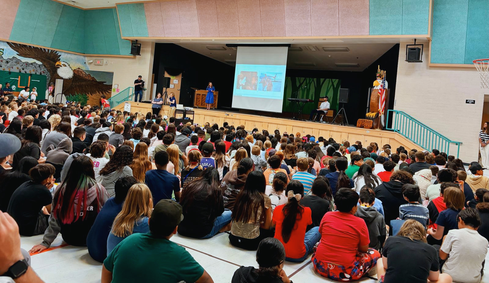 Jennifer Evans speaking to a packed school assembly of students