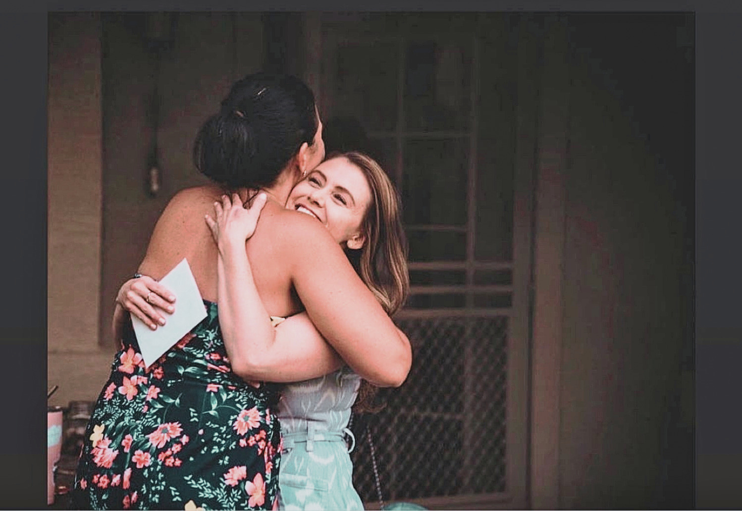 Jennifer Evans embracing a young woman warmly